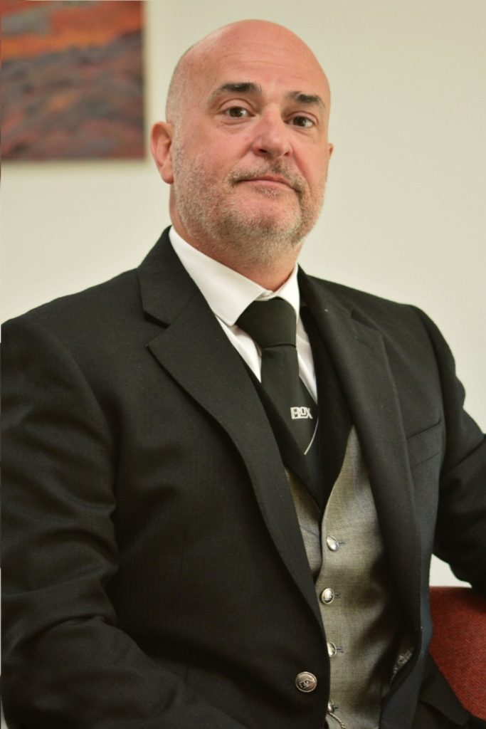 Plcture of Neil from Eric f box funeral home in mourning suit